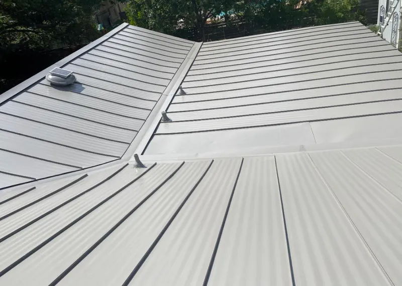 Solar attic fan installed on a metal roof for Roof Ventilation in Oakland